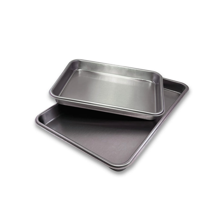 Two metal baking trays on a white background