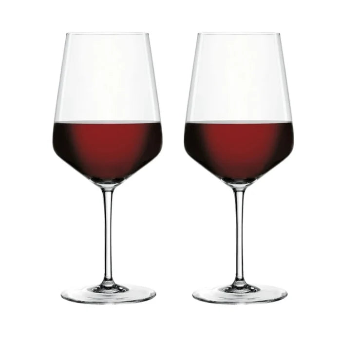 Two clear wine glasses filled with red wine, shown side by side on a plain white background.