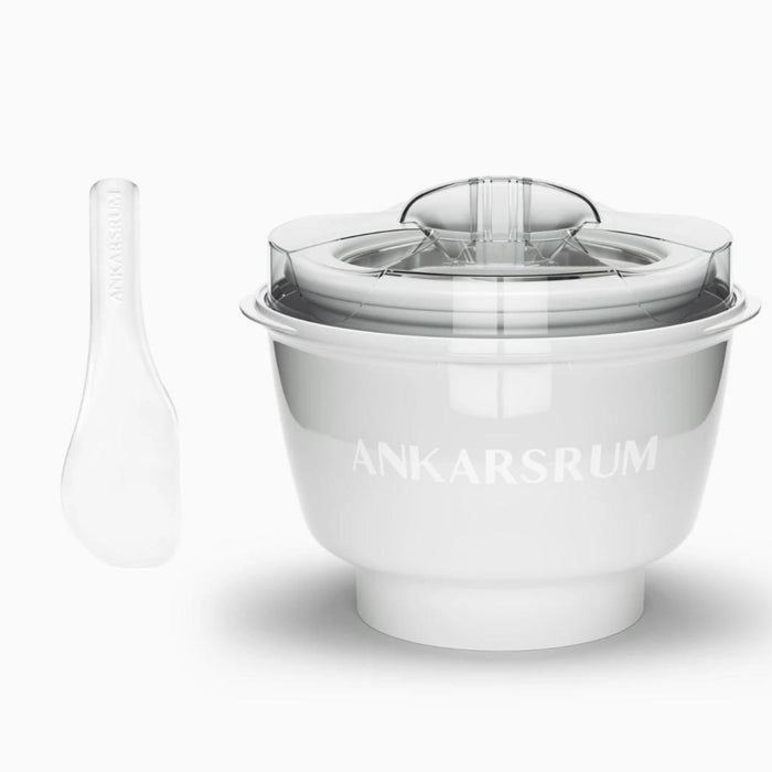 White ice cream maker with spatula displayed on a white background