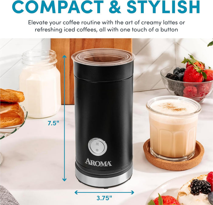 Black Aroma milk frother on a kitchen counter with a glass of coffee and berries in the background.