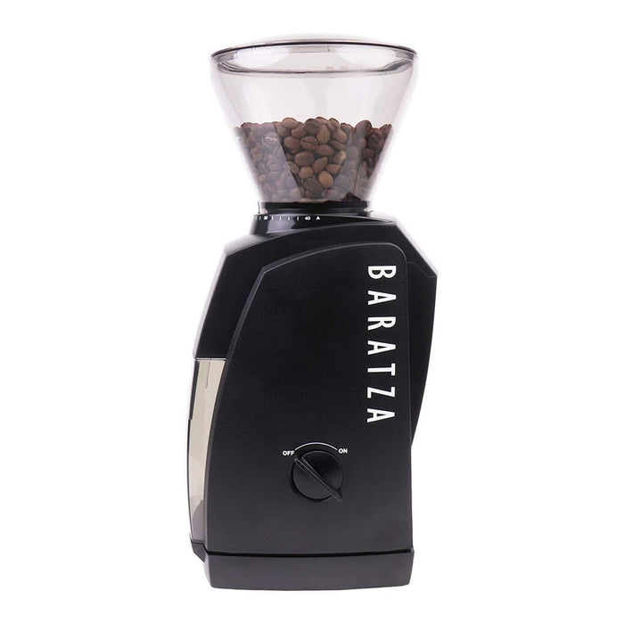 Side view of black Baratza coffee grinder with coffee bean filled bean hopper and power switch on a white background