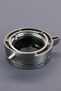 Gear for a coffee grinder displayed on a grey background