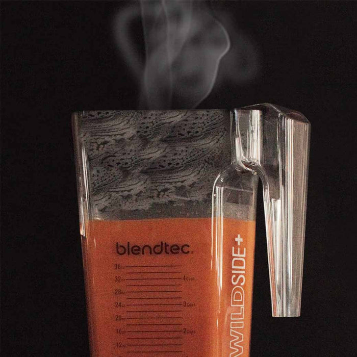 Blendtec wildside jar with steamy orange liquid displayed on a black background