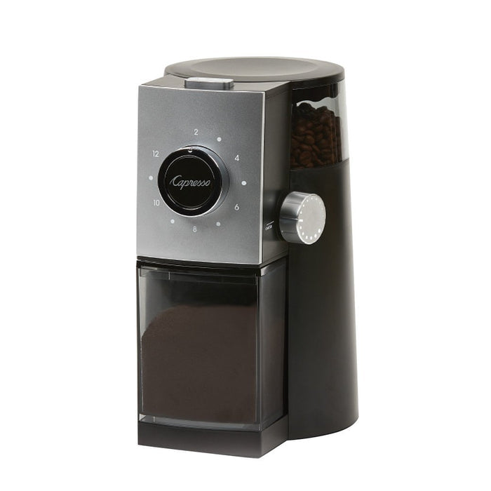 Capresso coffee grinder with coffee beans inside bean hopper and ground coffee inside clear container displayed on a white background
