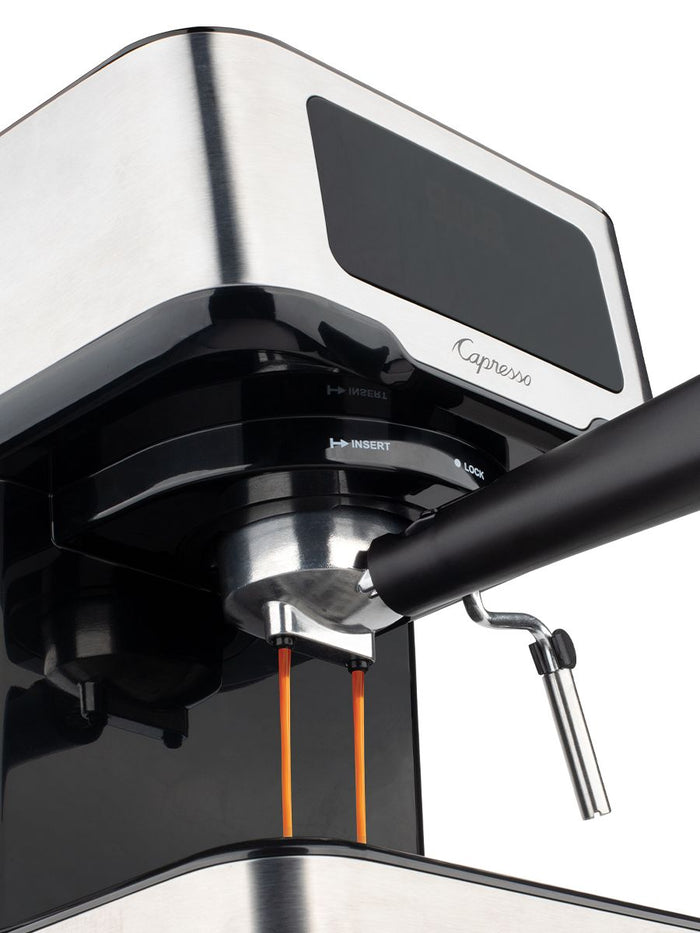 Coffee pouring out of Capresso coffee machine displayed on a white background