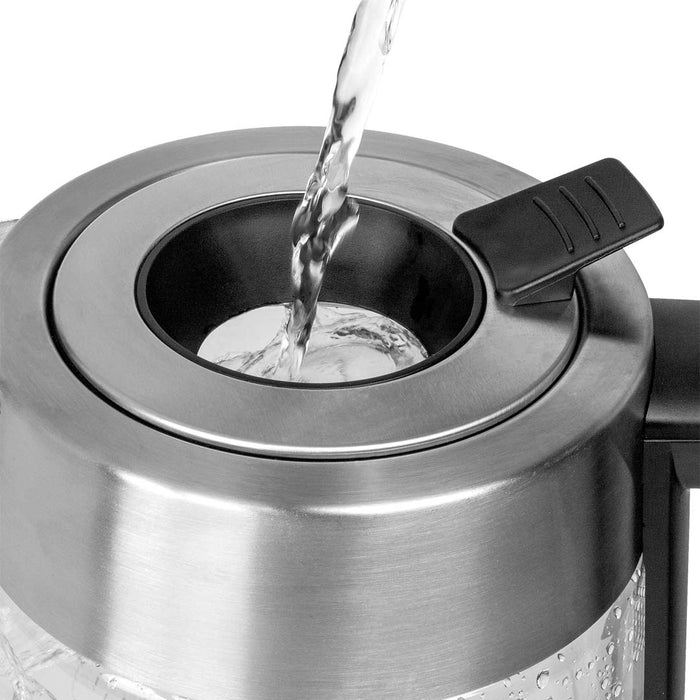 Water being poured into the top of 68 oz Capresso h20 glass electric kettle displayed on a white background