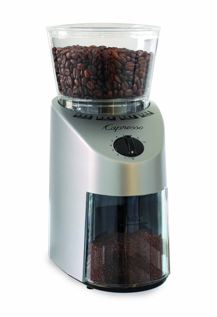 Coffee grinder with coffee beans on a white background