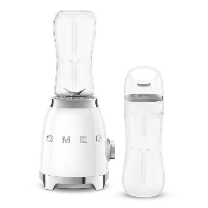 White Smeg retro line personal blender and clear tumbler on a white background