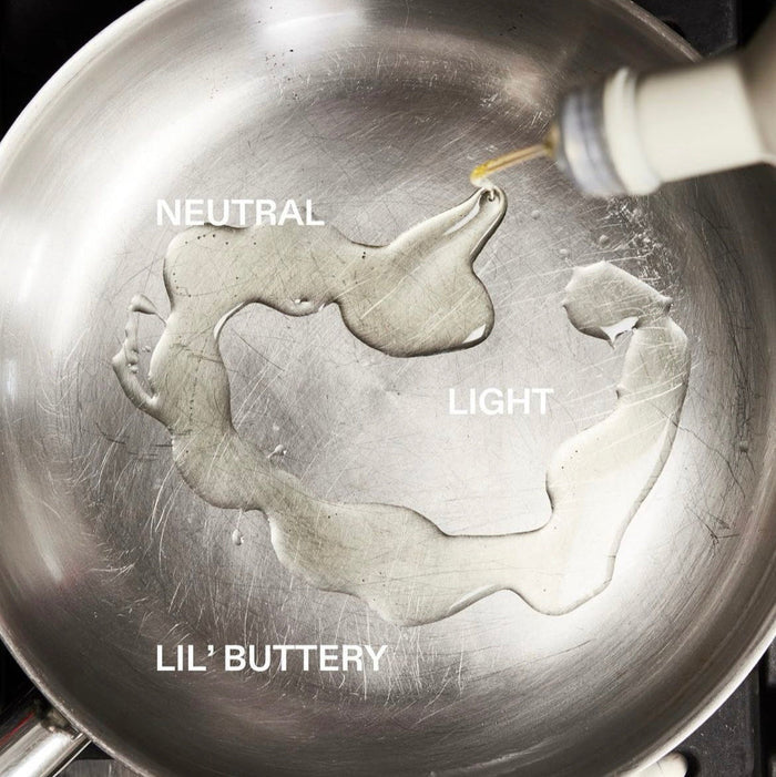 Oil being poured into a pan labeled 'Neutral', 'Light', and 'Lil' Buttery'.
