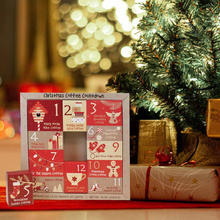 Christmas coffee countdown calendar with various coffee flavors displayed next to presents and a Christmas tree