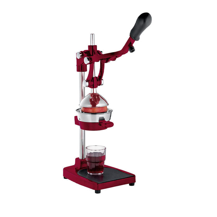 Frieling Cilio red juicer extractor and juice press with a pomegranate being pressed and a cup full of pomegranate juice displayed on a white background
