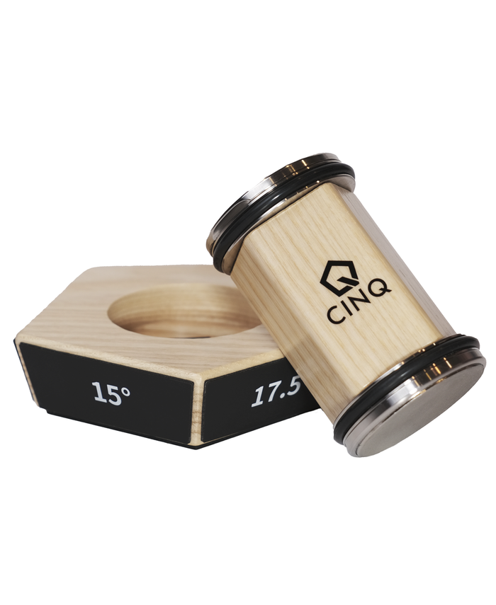 A CINQ brand rolling knife sharpener with a wooden base and metallic grit discs, displayed with a black level indicator.