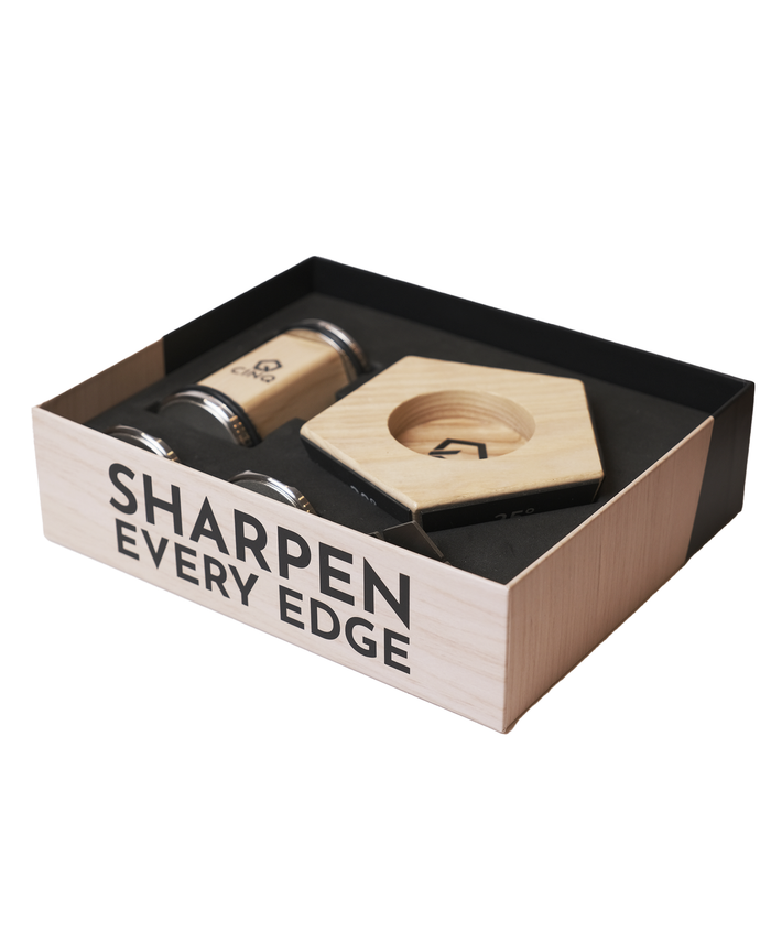The inside of the packaging of the Cinq rolling knife sharpener on a white background
