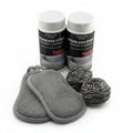 Two bottles of Heritage Steel Stainless Steel Powder Cleanser with cleaning pads and scrubbers on a white background.