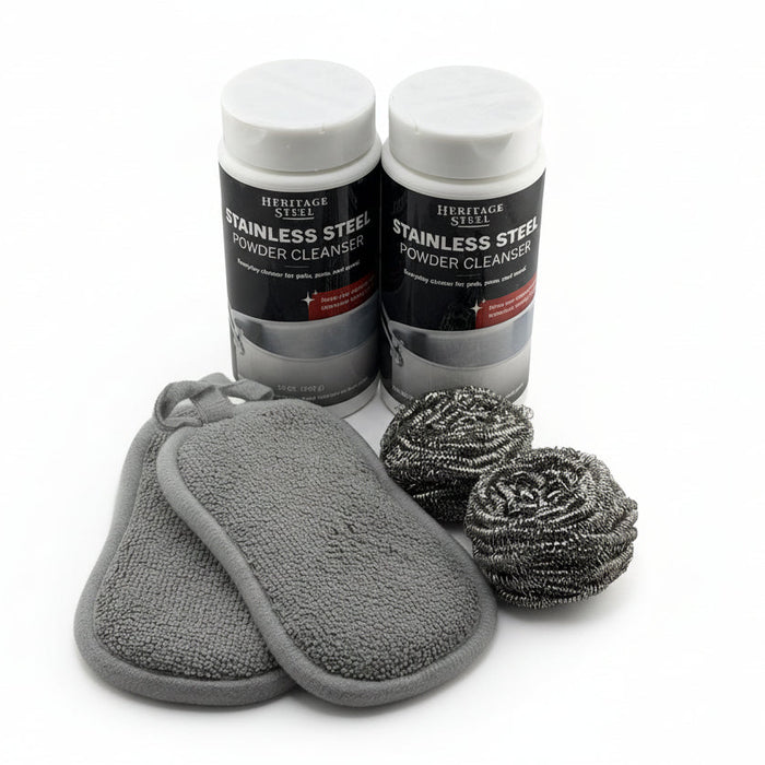 Two bottles of Heritage Steel Stainless Steel Powder Cleanser with cleaning pads and scrubbers on a white background.