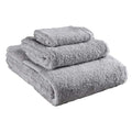 3 piece folded light grey Delilah Home 100 organic cotton bath towels displayed on a white background