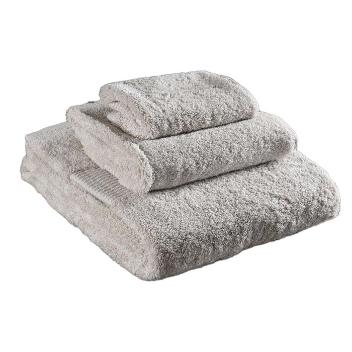3 piece folded natural Delilah Home 100 organic cotton bath towels displayed on a white background