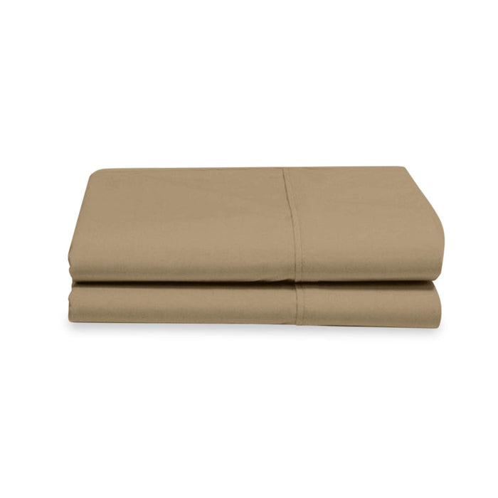 Folded beige bed sheet set on a white background