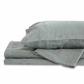 Light gray queen Delilah home 100 organic hemp duvet cover folded on each other with a pillow on top displayed on a white background