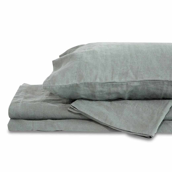 Light gray queen Delilah home 100 organic hemp duvet cover folded on each other with a pillow on top displayed on a white background