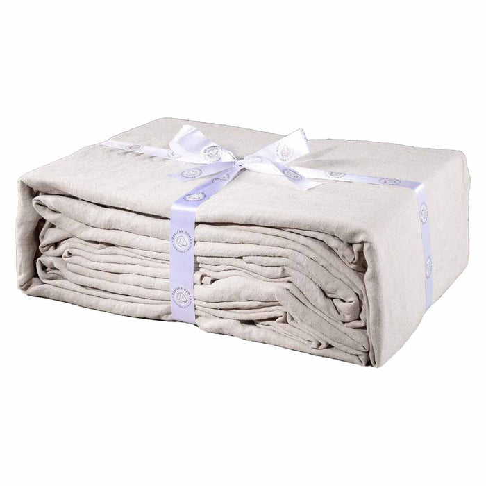A folded natural queen Delilah home 100 organic cotton duvet cover tied with a ribbon, on a white background.