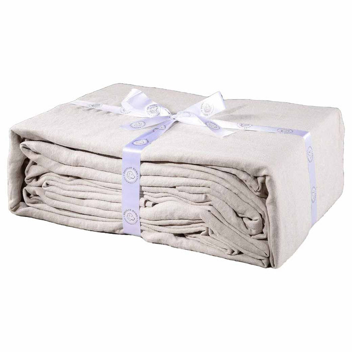 A folded natural king Delilah home 100 organic cotton duvet cover tied with a ribbon, on a white background.
