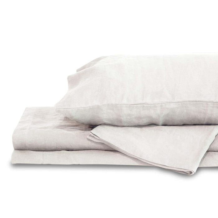 White queen Delilah home 100 organic hemp fitted sheet folded on each other with a pillow on top displayed on a white background