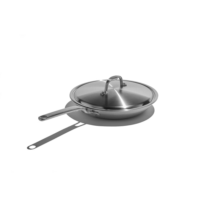 Stainless steel frying pan with lid on a white background