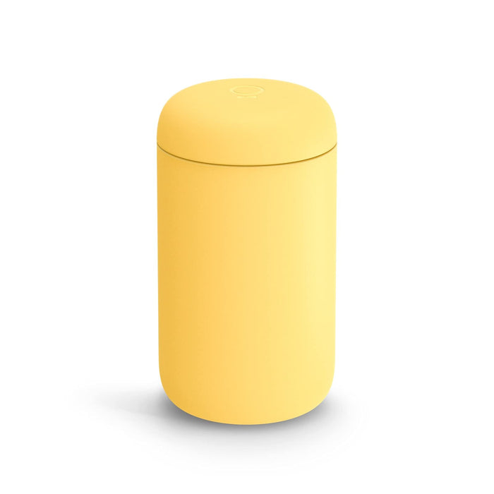 A 16 oz yellow Fellow Carter Everywhere Mug with a lid displayed on a white background