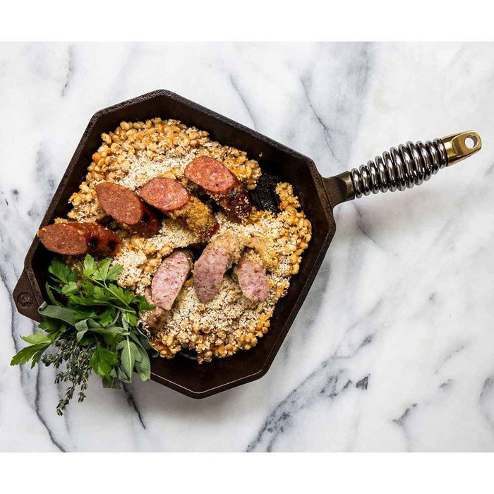 FINEX 10″ Cast Iron Grill Pan, Grillet displayed on a marble surface with food cooked on the grillet