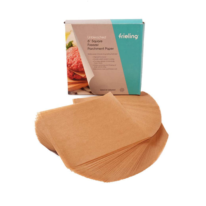 Frieling 6 inch square freezer baking sheets box with pre cut parchment paper spread out in front of box on a white background