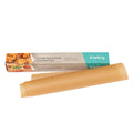 A roll of Frieling unbleached parchment paper with pre-cut sheets, displayed alongside its packaging which shows images of the paper being used for baking.