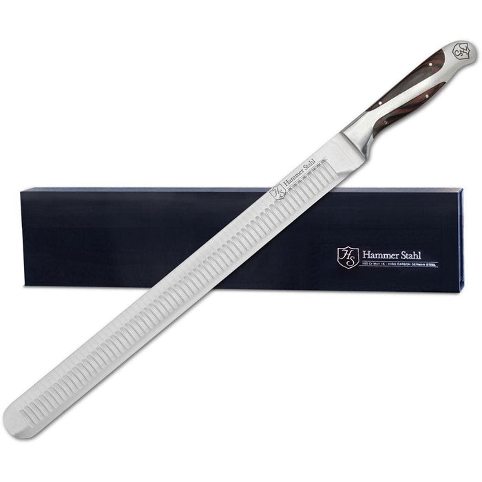 Hammer Stahl Slicer Knife with navy packaging behind knife displayed on a white background