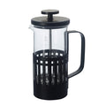 Black and clear French press coffee maker on a white background