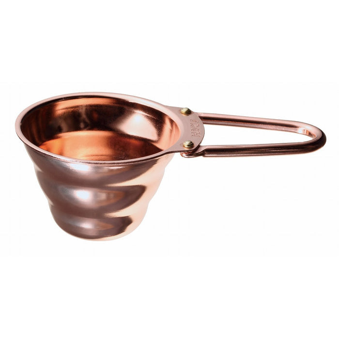 Copper Hario V60 measuring spoon displayed on a white background