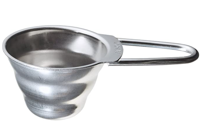 A silver Hario V60 measuring spoon with a looped handle designed for coffee measurement.