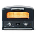 Front view of matte black toaster oven on with knobs displayed on a white background