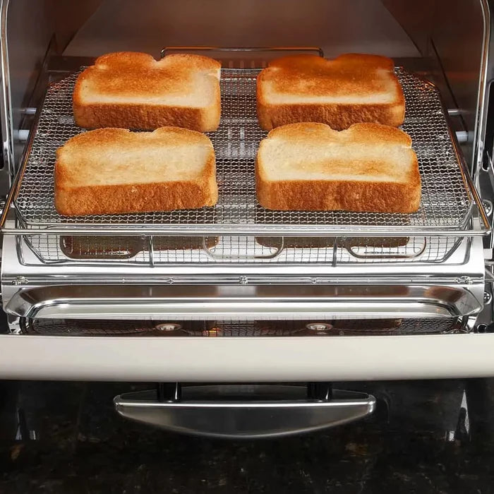 Four slices of golden-brown toasted bread arranged on a metal wire rack inside a toaster oven.