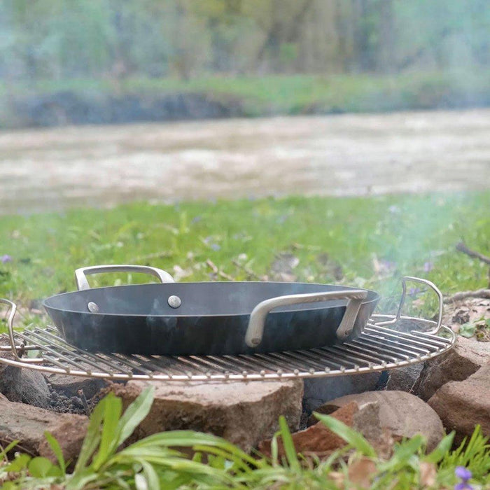 ICON griddle on a campfire in an outside setting
