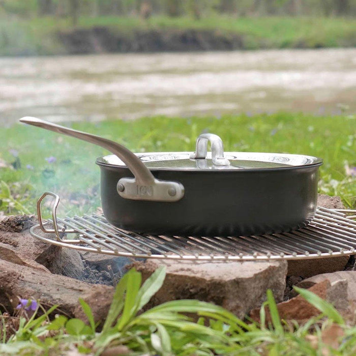 ICON saucepan with lid on a campfire outside