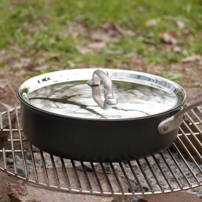 ICON saucepan with lid on a campfire outside