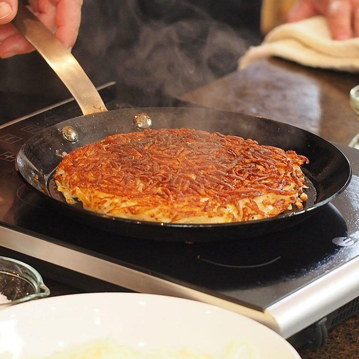 ICON Crepe/Steak Pan - 9.5″cooking a hashbrown on a portable stovetop