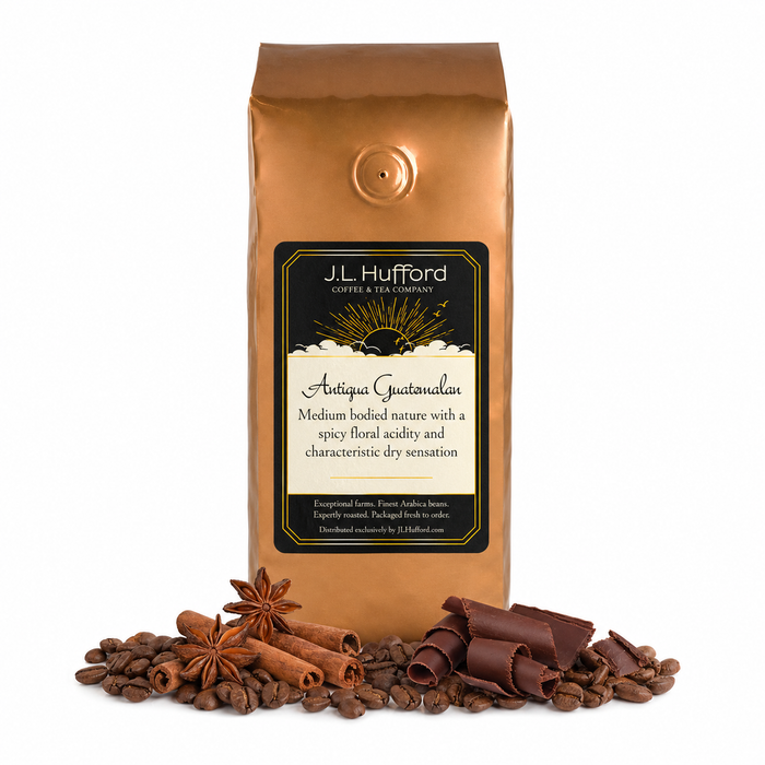 1 lb J.L. Hufford Antigua Guatemalan coffee bag with coffee beans, chocolate shavings and cinnamon sticks in front of the coffee bag