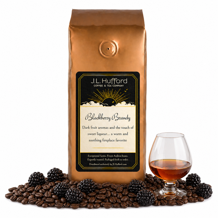 1 lb Blackberry Brandy coffee beans bag with coffee beans, blackberries and glass of brandy in front displayed on a white background