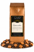 1 lb J.L. Hufford Butter Scotchies Coffee with coffee beans and butterscotch in front displayed on a white background