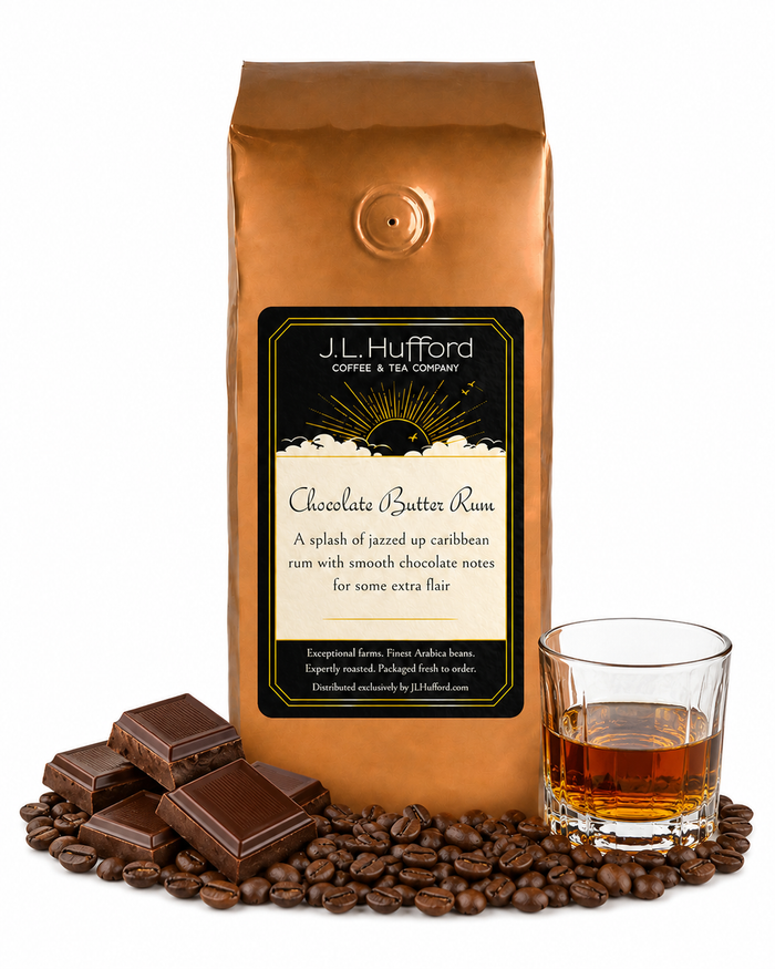 1 lb J.L. Hufford Chocolate Butter Rum coffee bag with coffee beans, milk chocolate bar, and a glass of rum on a white background