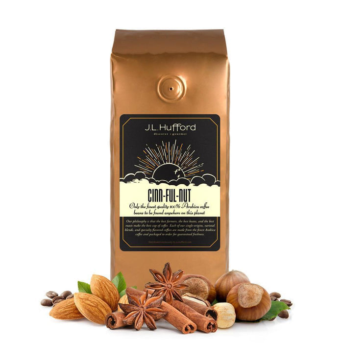 1 lb cinnfulnut coffee bag with 'J.L. Hufford' branding, cinnamon sticks, and hazelnuts on a white background