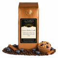 1 lb Cinnamon Blueberry Crumble coffee beans bag with coffee beans, blueberries, cinnamon sticks, and blueberry crumble muffin in front displayed on a white background