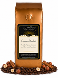 1 lb Cinnamon Hazelnut coffee beans bag with coffee beans, cinnamon sticks, and hazelnuts in front displayed on a white background