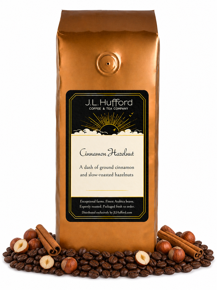 1 lb Cinnamon Hazelnut coffee beans bag with coffee beans, cinnamon sticks, and hazelnuts in front displayed on a white background